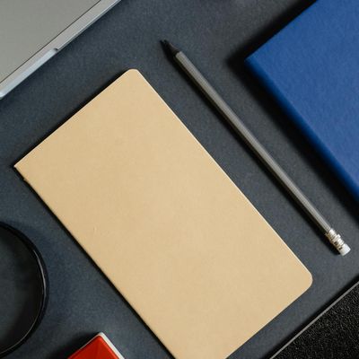 Stylized blue image of a laptop and notebook